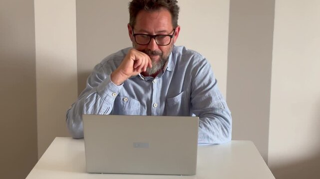 Man sit on desk in living room look at laptop screen start conversation use videocall app. E-employment, pass job interview remotely, business solutions via videoconference start up small business