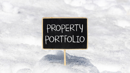 Property portfolio symbol. Concept words Property portfolio on beautiful yellow blackboard. Beautiful white snow background. Business Property portfolio concept. Copy space.