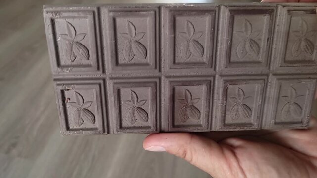 a bar of chocolate with a white coating. expired or spoiled chocolate
