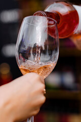 Adult holds up a glass  wine enjoying the pleasant weatherAdult holds up a glass  wine enjoying the pleasant weather