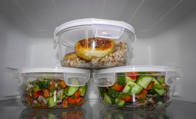 glass food containers with salad in the refrigerator. Storage system