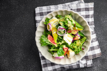 fig salad green lettuce, figs, soft cheese fresh meal food snack on the table copy space food background rustic top view keto or paleo diet vegetarian vegan food