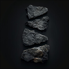 Fototapeta premium Four Dark Stones on a Black Background 