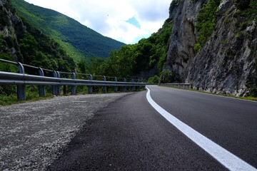 Picturesque view of rocky cliff and asphalt road in mountains