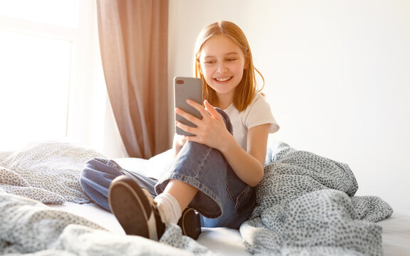 Cute Little Talking With Video Messenger On A Smartphone, Video Conversation With Friend