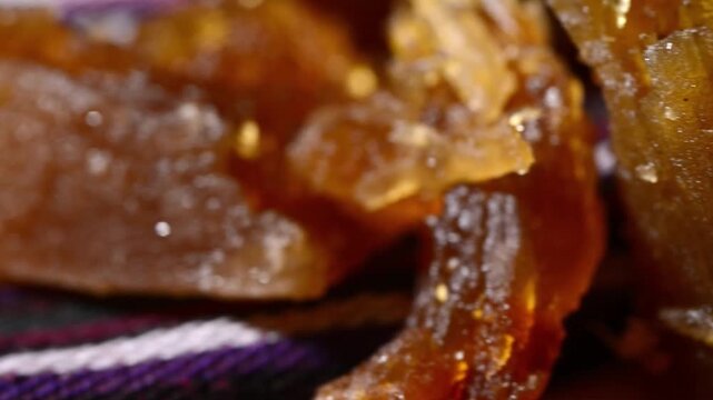 Close-up video of traditional Salvadoran Chilacayote candy, a sweet, caramelized dessert enjoyed during festive August fairs.
