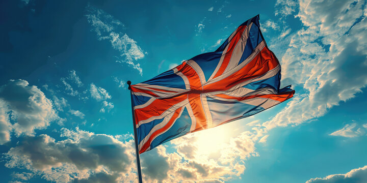 The national flag of the united kingdom, also known as the union jack, is waving proudly in the wind against a cloudy sky.UK flag. Banner. Copy space - Powered by Adobe