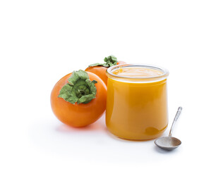 Persimmon purree in glass jar isolated on white