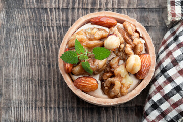 Tart with nuts and caramel on a rustic wooden background
