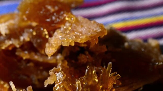 Close-up video of traditional Salvadoran Chilacayote candy, a sweet, caramelized dessert enjoyed during festive August fairs.