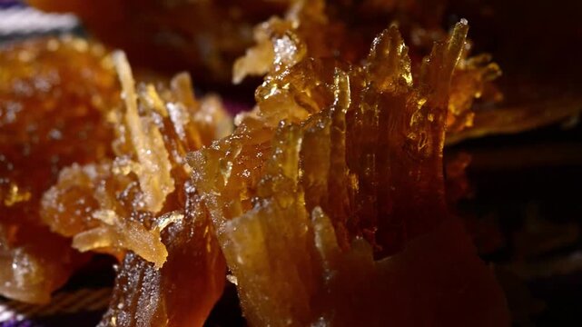 Close-up video of traditional Salvadoran Chilacayote candy, syrupy and sweet, showcasing rich textures and vibrant fairground colors.Close-up video of traditional Salvadoran Chilacayote candy, a sweet