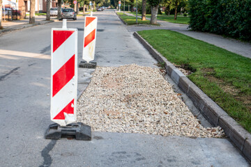 Road repair, piled stone chips before laying asphalt