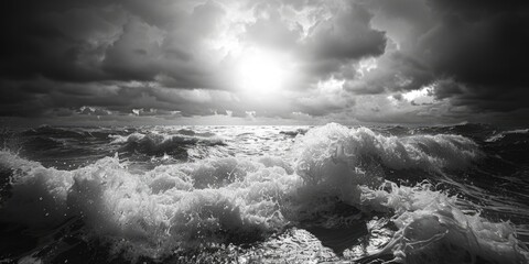 A black and white photograph of the ocean with waves and foam