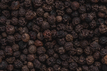 Black pepper background. Close-up of black peppercorns.