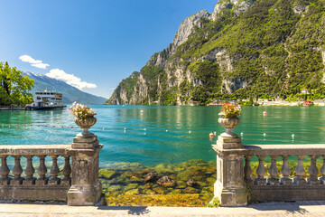 Lake Garda with mountains in background, view from Riva del Garda town shore, Italy, Europe.