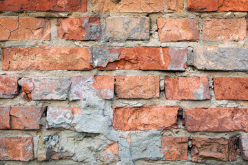 Old Brick Wall with Crumbling Mortar. A detailed view of an old brick wall with visible signs of wear and crumbling mortar.