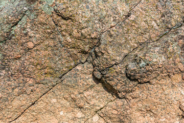 Texture of natural stone, boulder with diagonal cracks and relief convex surface. Nature abstract...