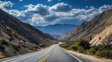 Fototapeta premium Malibu Road: Scenic Mountain Pass with Desert Landscape and Clear Blue Sky