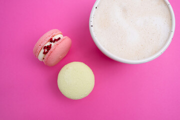 Macarons on a colored background, French cookies. Gift for March 8, International Women's Day, Valentine's Day. Sweets for coffee and tea