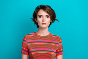 Fototapeta premium Photo of serious gorgeous woman with short hairstyle dressed striped t-shirt look at camera isolated on turquoise color background