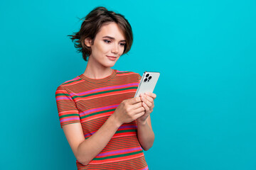 Portrait of intelligent nice girl with bob hairdo wear stylish t-shirt look at smartphone read...
