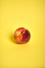 Single Peach on Yellow Background