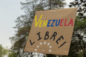 Venezuela opposition, People protest against presidential election results, holding banner signs on city streets. Democracy and activism