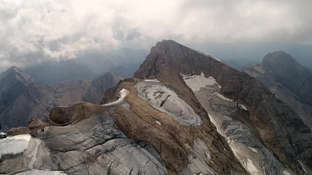 Aerial view of Punta Penia the top of Marmolada mountain glacier in Dolomites, Alps, Italy. Massif glacier. Evidence of global warming and melting glaciers