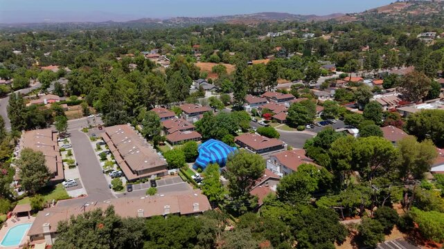 This aerial image shows a wellmaintained residential property with a comprehensive pest control system, including a termite wrap and specialized treatments in a vibrant suburban area