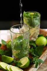 Detox drink with mint lime and mineral water in a glass jar