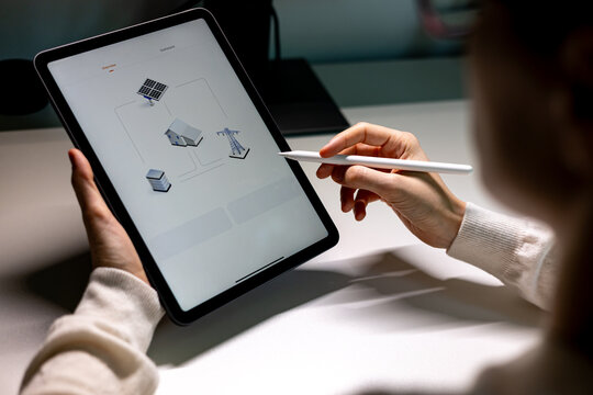 Woman with smart device monitor home electricity production by photovoltaic panels. People check energy usage to save electricity bills.