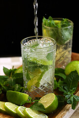 Detox drink with mint lime and mineral water in a glass jar