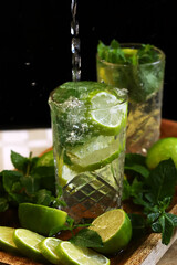 Detox drink with mint lime and mineral water in a glass jar