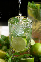 Detox drink with mint lime and mineral water in a glass jar