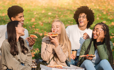 Blondy girl having picnic with her multiracial friends, enjoying tasty pizza outdoors
