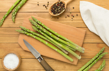Fresh asparagus on wooden background, top view