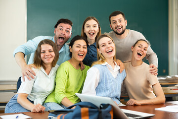 Group portrait of a positive group of young students in a university auditorium