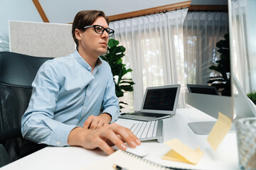 Fototapeta premium IT developer looking at online software development information on pc align working laptop with coding program on updated version application project trial creating new code overall system. Pecuniary.