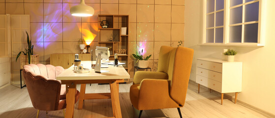 Interior of studio with podcaster's workplace and glowing lamps