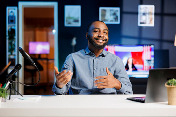 Cheerful BIPOC content creator doing travelling recommendations type of video for fans, giving...