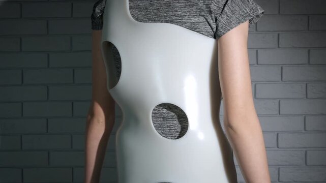 Healthcare medicine with corset. A teen in medical orthopedic corset takes care of her scoliosis. A concept of healthcare for back disease.
