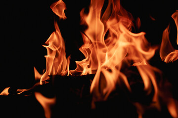Fire over black background. Fire sparks background. Abstract blaze flames background. Burning fire....
