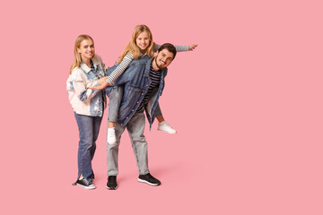 Fototapeta premium Happy family in stylish denim clothes on pink background
