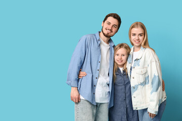 Happy family in stylish denim clothes on blue background