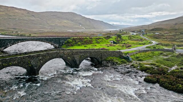 Aerial view of a curved old bridge, Tourist attraction in Scotland. Scottish Highlands Sligachan Old Bridge on the Isle of Skye.