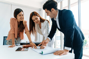 Fototapeta premium Businessman is in meeting discussion with colleague businesswomen in modern workplace office. People corporate business team concept. uds