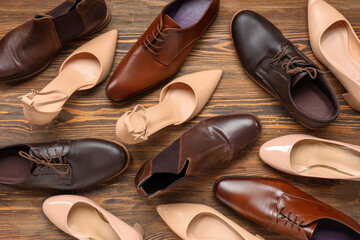 Male and female shoes on wooden background. Top view