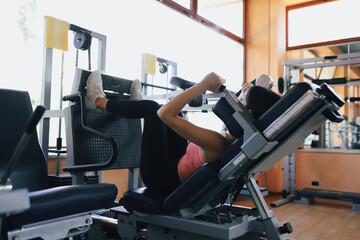 Woman Pushing On The Leg Press To Lift Weight 