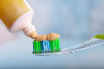 Toothbrush and miswak extract toothpaste. On the toothbrush, squeeze out the toothpaste on a blue...