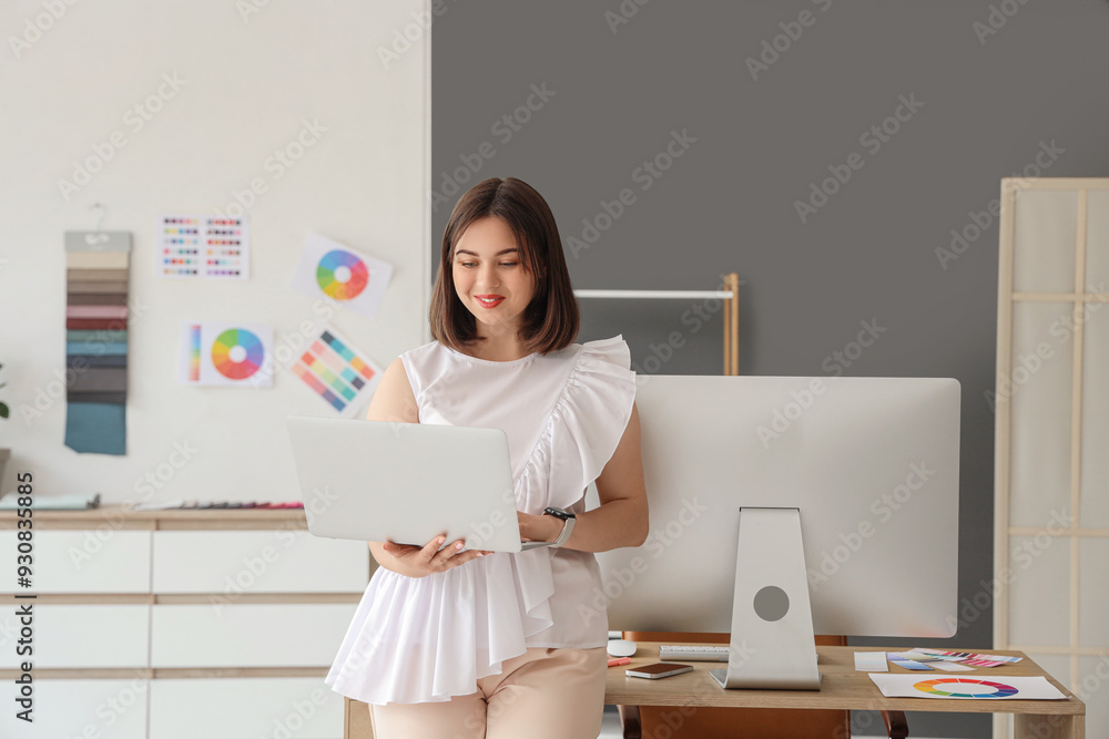 Sticker young female interior designer working with laptop in office